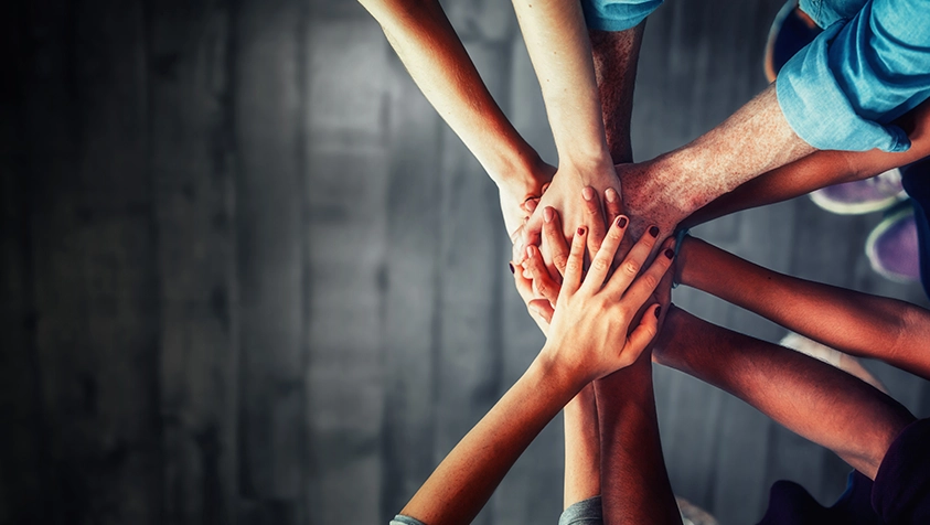 Hands All Together for a Team Huddle | MicroAccounting